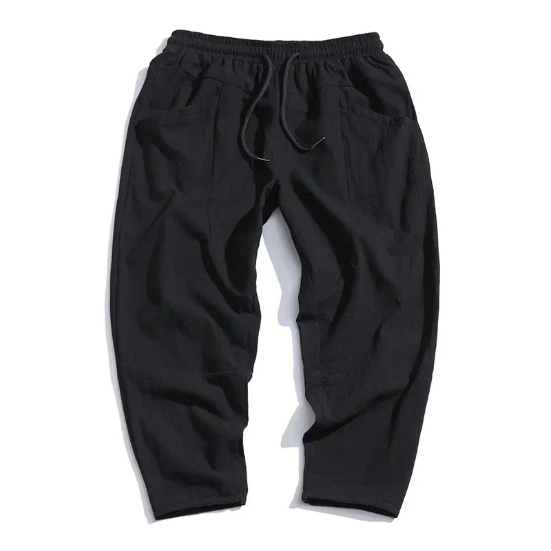 Modern men's casual cropped pants featuring a drawstring waist and relaxed fit, perfect for comfortable wear.