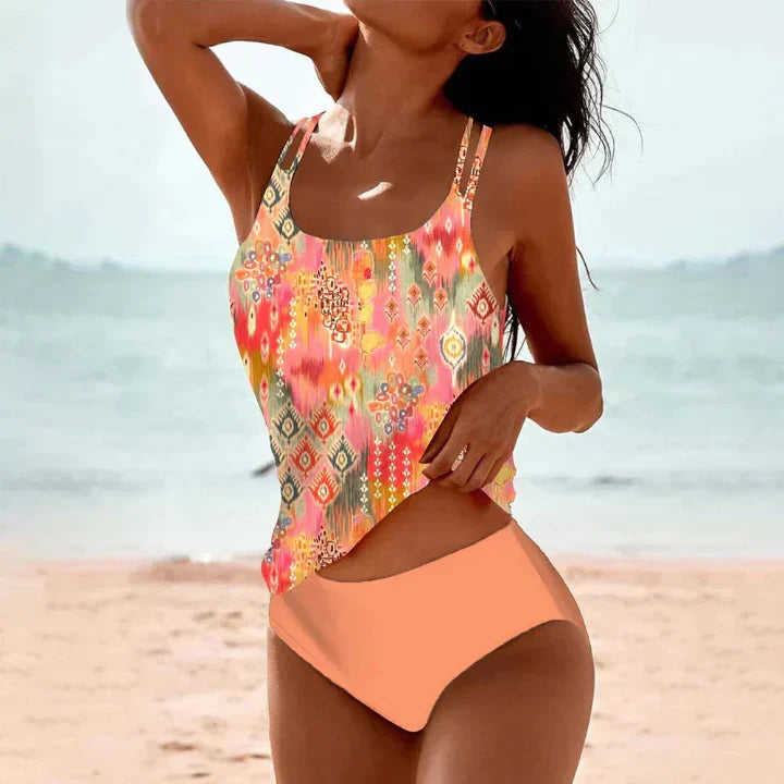 Women's vibrant patterned tankini top and coordinating boxer swim shorts, a stylish two-piece swimsuit for summer.