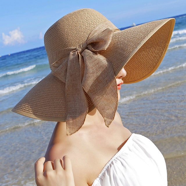 Breathable women's wide-brim straw hat. Essential sun protection for beach, travel, and outdoor wear.