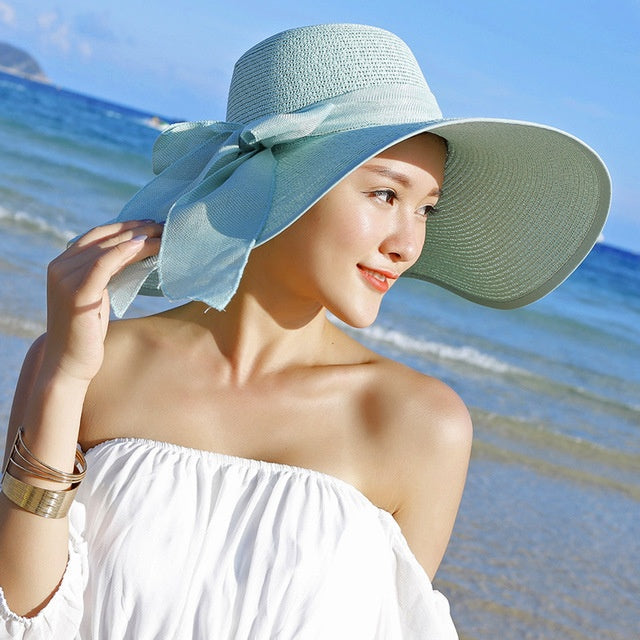 Candy-colored women's straw hat, offering ultimate sun protection for beach days & summer travel.