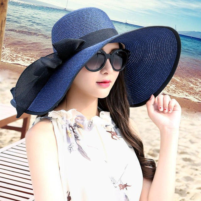 Stylish women's straw hat with wide brim, breathable design for beach, vacation, & sun protection.