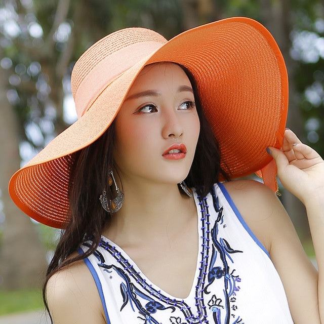 Colorful women's straw hat with sun protection. Perfect wide-brim beach hat for stylish summer vacations.