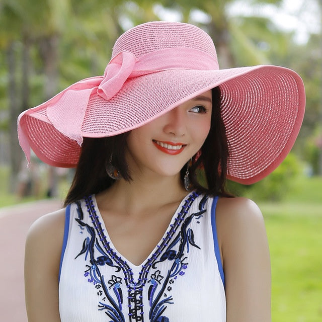 Chic women's sun protection straw hat. Breathable, wide-brim design, ideal for beach, travel, & outdoor fashion.