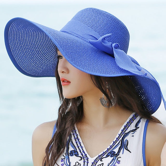 Women's wide-brim straw hat for sun protection. Stylish, breathable, perfect for beach, pool, and travel.