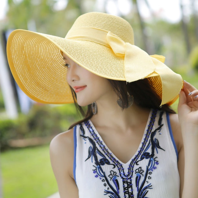 Fashion-forward women's sun protection straw hat. Breathable wide brim, ideal for beach & summer adventures.
