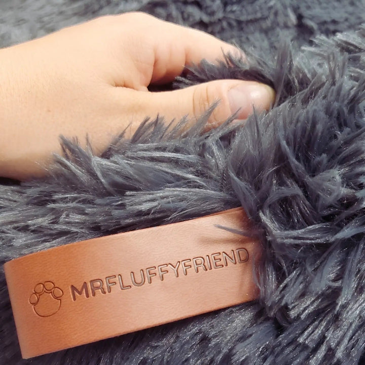 Close-up of the soft, durable plush fabric of a comfortable dog bed, designed for restful sleep.