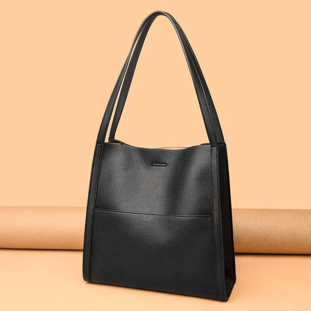 Stylish women's spacious brown leather handbag. Perfect large capacity shoulder bag for daily essentials.