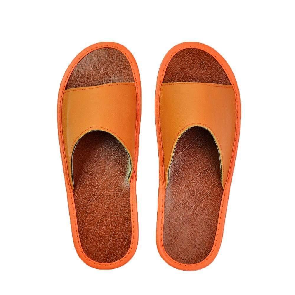 Pair of women's comfort slippers in a neutral color, wide fit, with supportive cushioning.