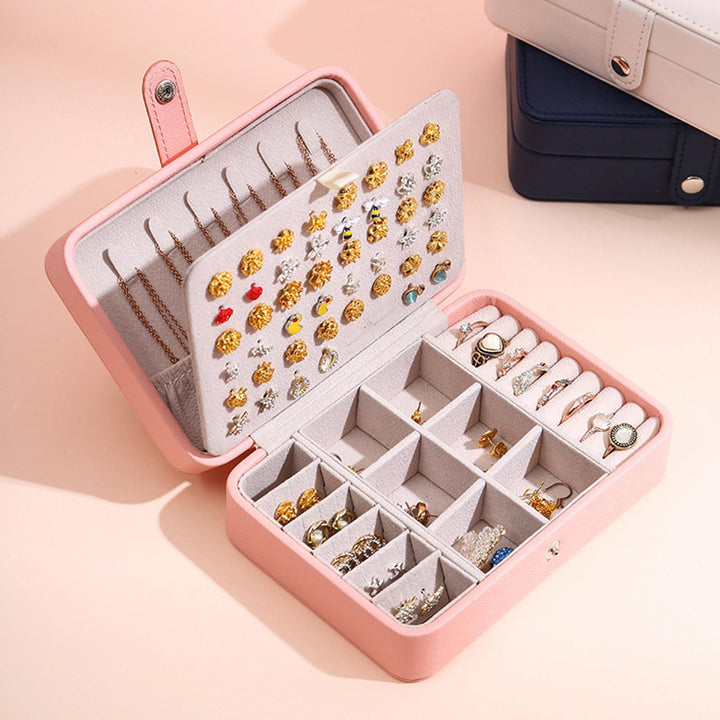 Organized storage: White flip-top jewellery box, a stylish accessory holder.
