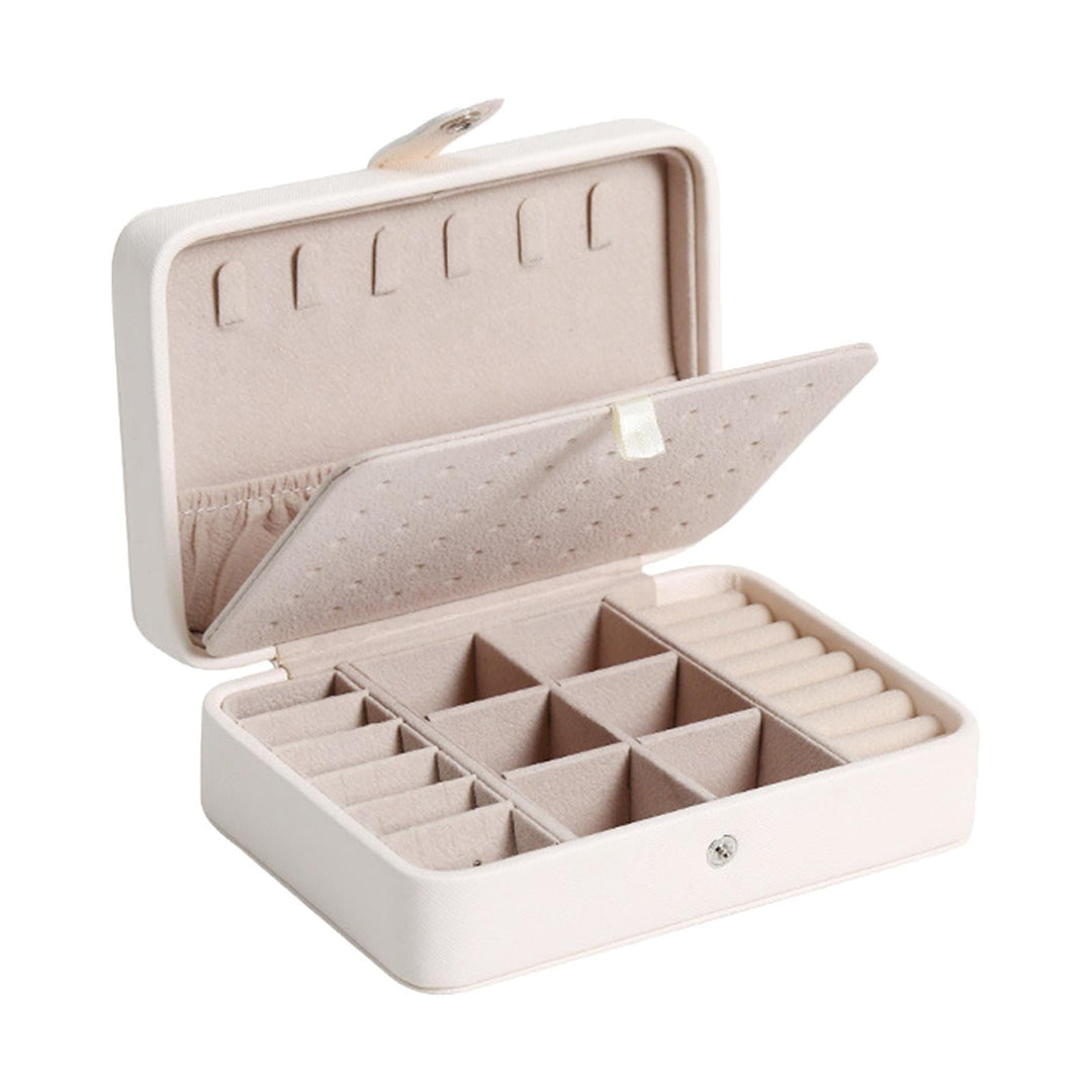 White leather jewellery organizer with flip-top lid, perfect for accessories.
