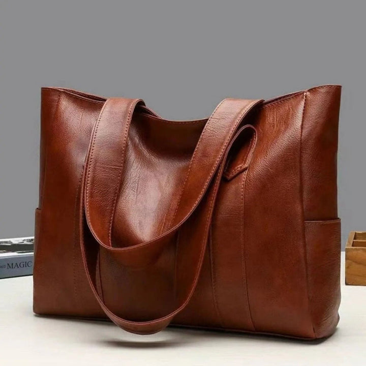 Stylish black women's shoulder bag, a versatile everyday tote. Perfect for work, daily errands, or chic casual wear.