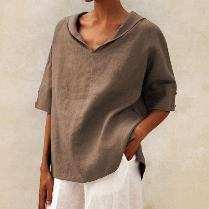 Flat lay of a women's V-neck casual summer blouse, showcasing its effortless style and comfortable design.