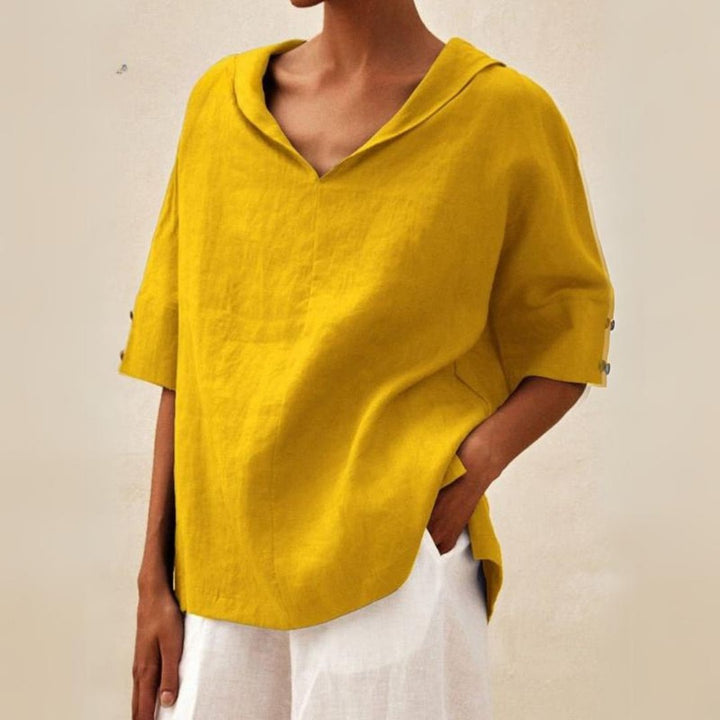 Model wearing a stylish women's V-neck casual summer blouse, demonstrating its loose fit and short sleeves.