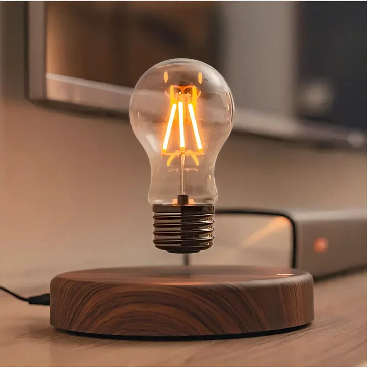 Unique floating bulb desk lamp on a solid walnut wood base, a modern and eye-catching office gift.