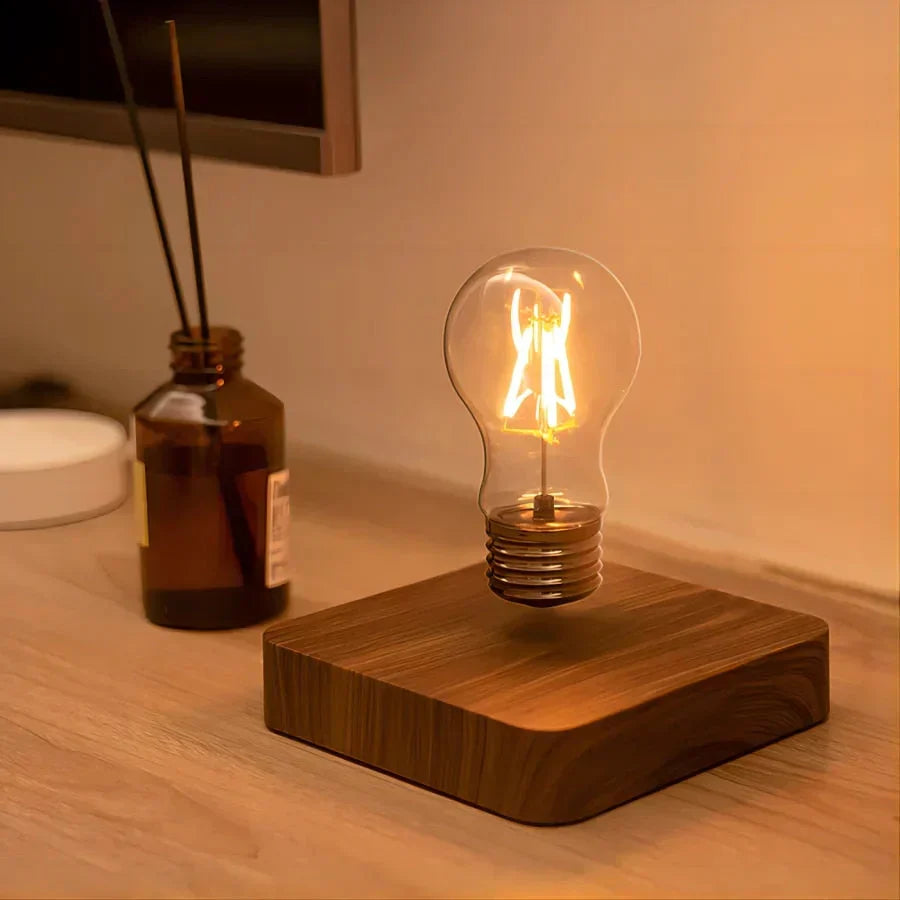 Modern floating light bulb lamp featuring a rich walnut wood base for unique home and office ambiance.