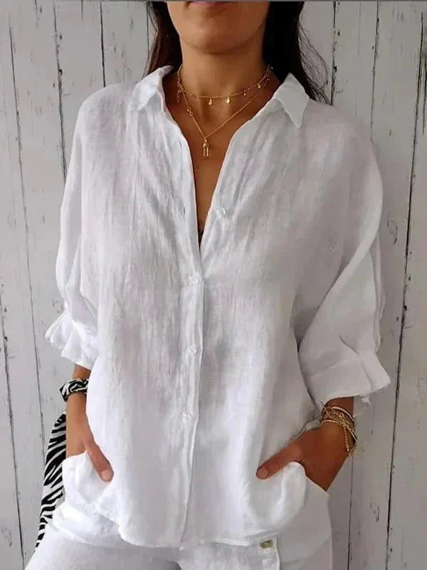 White women's relaxed fit linen button-down shirt with elegant rolled cuffs, ideal for sophisticated everyday style.