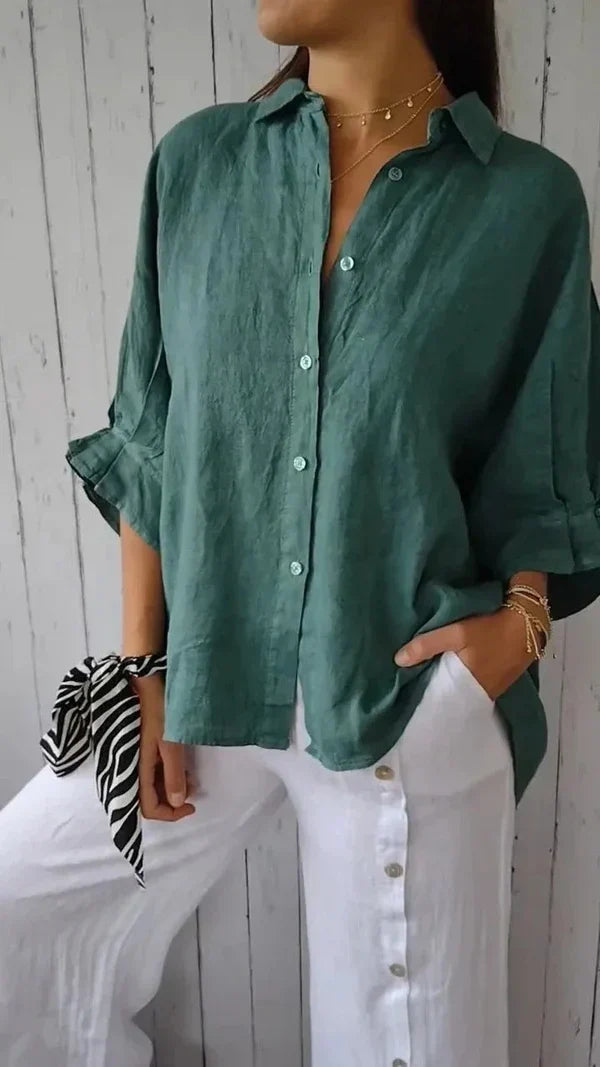 Women's sophisticated button-down linen shirt, relaxed long-sleeve fit with chic rolled cuffs, available in various colors.