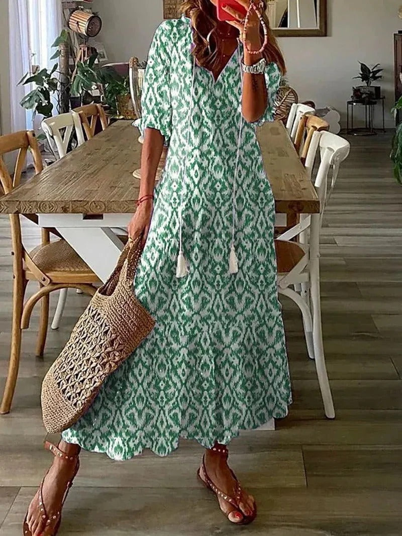 Chic V-neck A-line women's long dress, elegant leaf pattern and flowy boho style for casual or dressy wear.