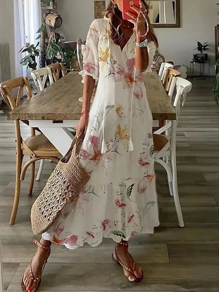 Women's patterned boho maxi dress, flowy long summer dress with a stylish leaf print, V-neck design.
