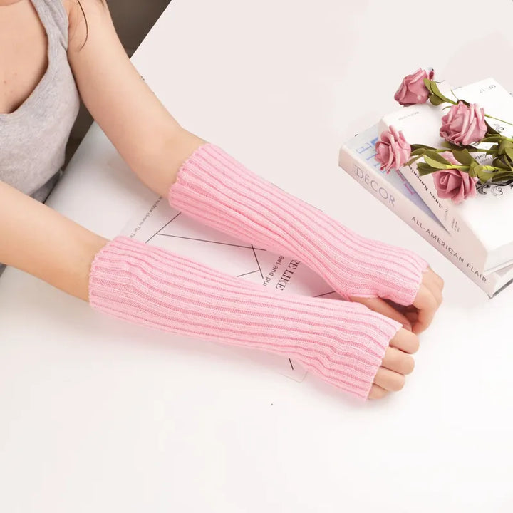 Women's long fingerless knitted winter gloves in a cozy, stylish design. Perfect arm warmers for warmth.