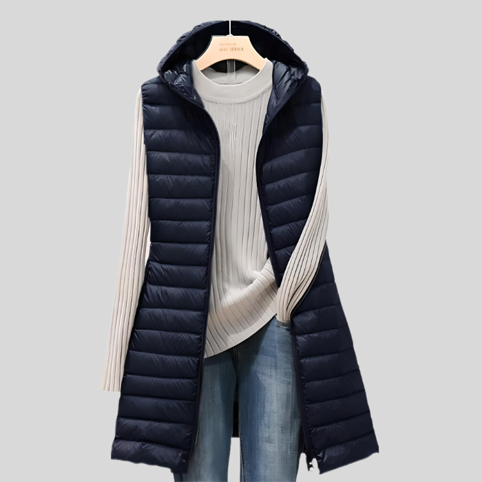 Stylish women's long puffy vest, sleeveless design & zipper closure, a cozy modern outerwear piece.