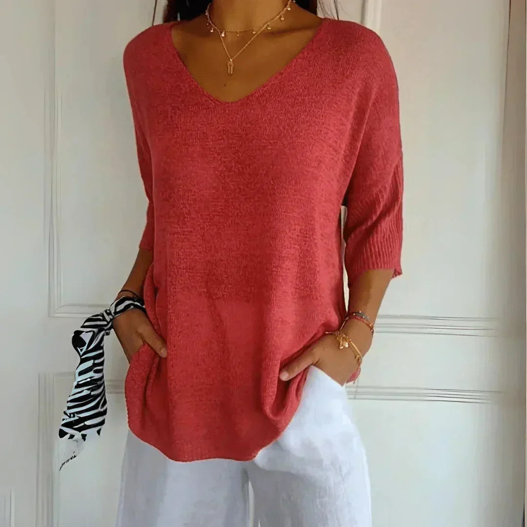 Women's relaxed V-neck knit top with 3/4 sleeves, ideal for comfortable casual everyday wear.