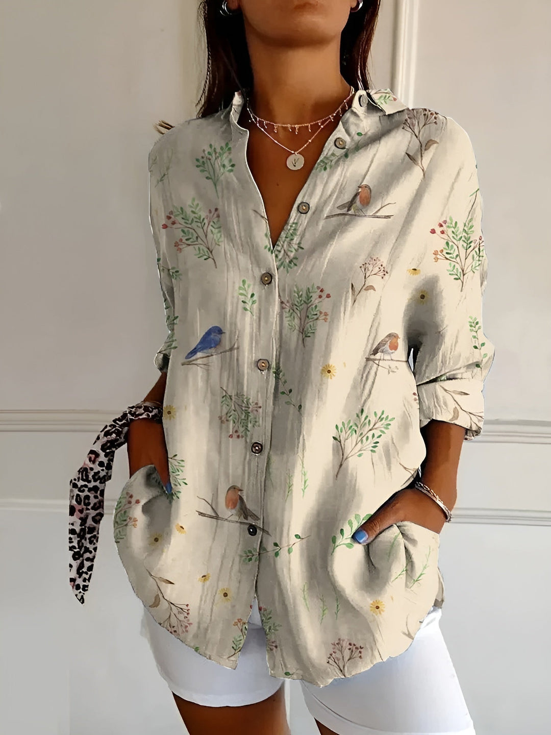Vibrant floral print women's button-up shirt in a relaxed fit with 3/4 sleeves for casual summer days.