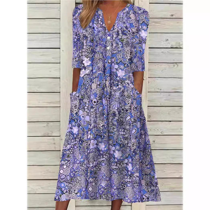 Elegant women's V-neck floral midi dress. Features delicate flower print, practical pockets & flowy silhouette.