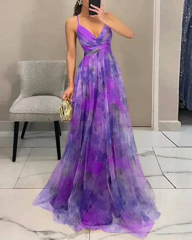 Chic women's A-line maxi dress, featuring delicate spaghetti straps, a V-neck, and vibrant watercolor art.