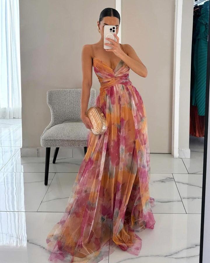 Summer-ready elegant spaghetti strap maxi dress with a captivating watercolor print and flowing skirt.