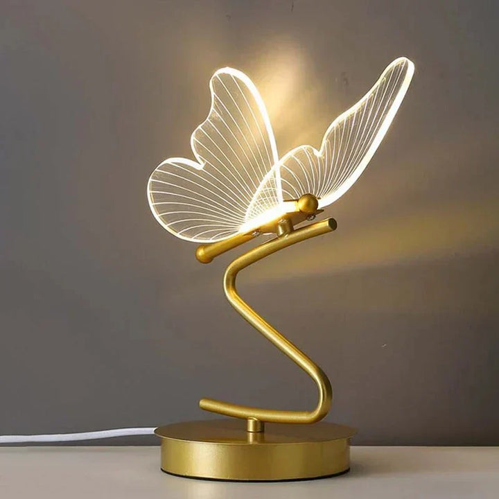 Decorative butterfly LED table lamp, casting a soft glow. Perfect modern home decor accent for bedroom or living room ambiance.