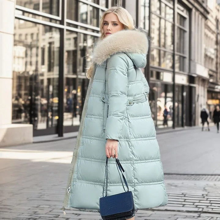 Elegant faux fur collar detail on a warm women's luxury winter coat, sophisticated style.
