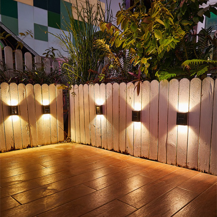 Modern solar LED wall light illuminates garden pathways & patio areas, enhancing outdoor security & decor at dusk.