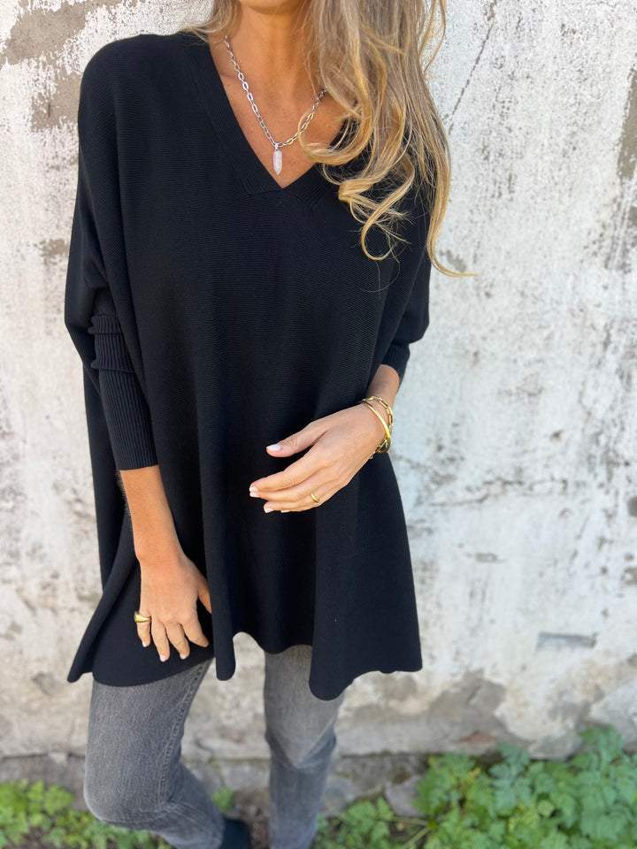 Women's oversized V-neck long sleeve knit top for casual everyday comfort.
