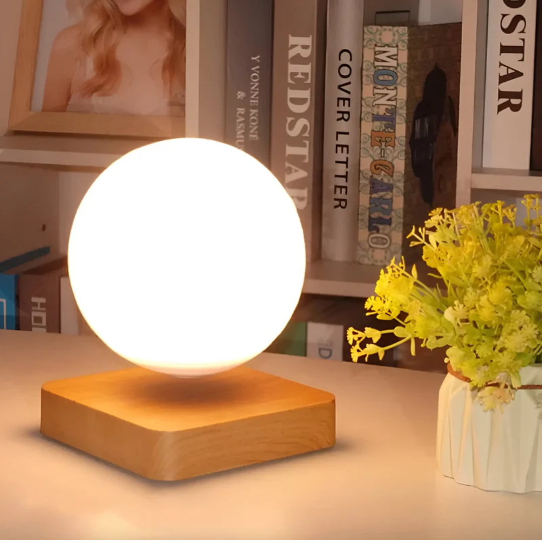 Touch control floating moon lamp providing warm ambient LED lighting. A unique night light for modern bedroom decor.