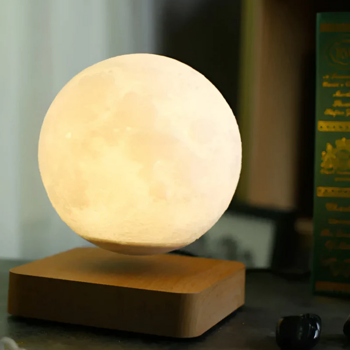 Floating moon lamp levitating over a magnetic base, emitting soft ambient LED light. Modern home decor for any room.