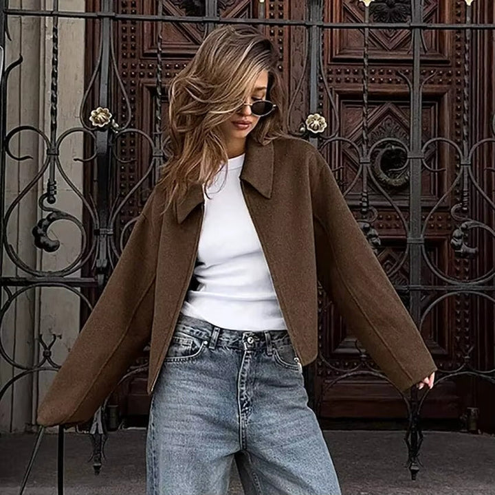 Trendy women's collared jacket with a functional zipper, ideal outerwear for spring, fall, or winter style.