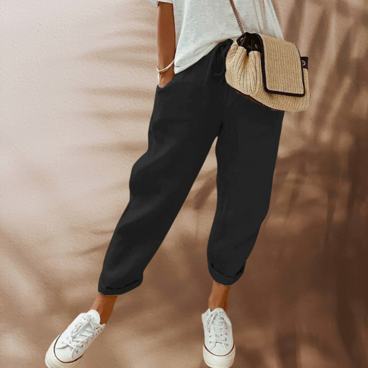 Comfortable women's cropped linen pants with a drawstring waist for chic, versatile everyday fashion.