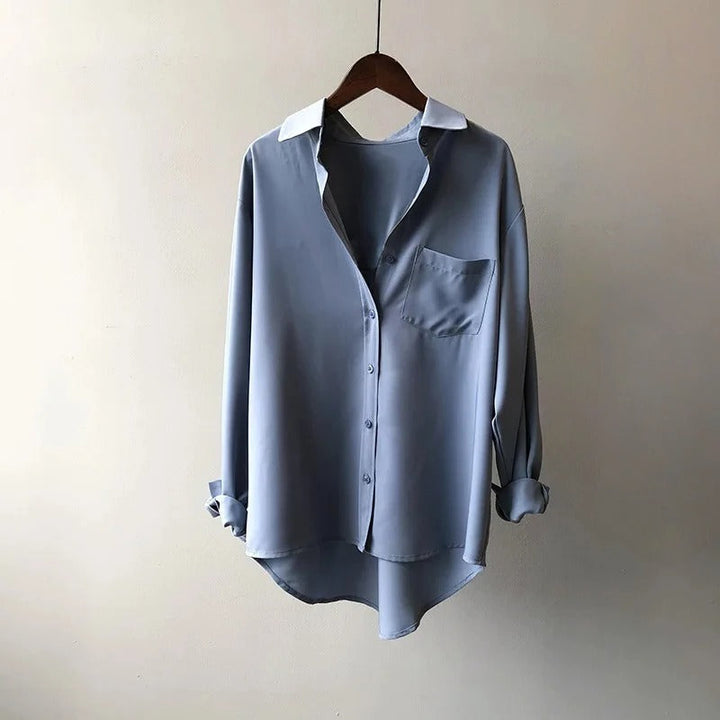 Relaxed fit women's long sleeve button-up blouse. Comfortable top for everyday fashion, casual style or office elegance.
