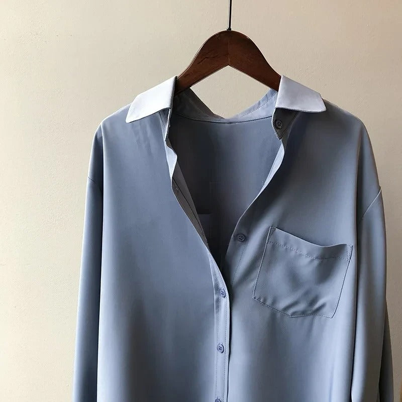 Stylish women's long sleeve button-up blouse. Collared shirt, perfect for various casual and professional occasions.