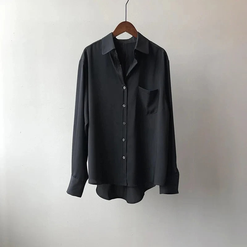 Women's long sleeve button-up blouse. Styled for an elegant office outfit or a relaxed, fashionable casual look.
