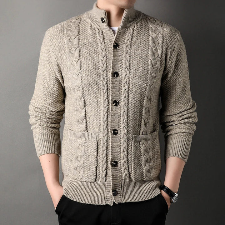 Refined men's cable knit cardigan, ideal for layering. Stand collar, button-up design for warmth.