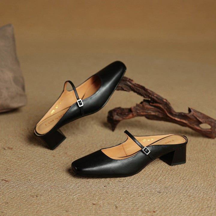 Unique square toe womens Mary Jane mules, with block heel and fashionable buckle detail.