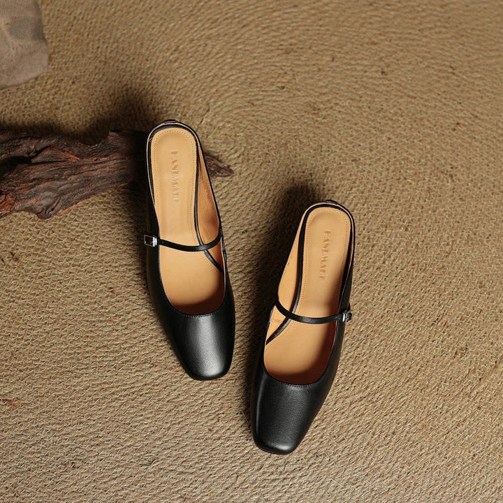 Womens Mary Jane mules, designed with a classic buckle, block heel, and square toe.