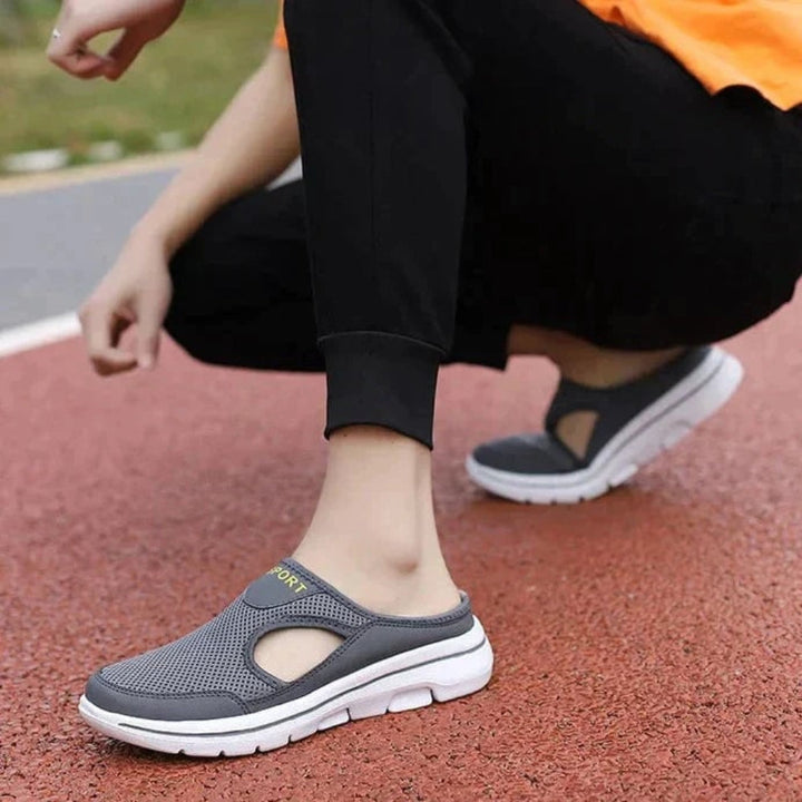 Men's supportive orthopedic slippers featuring arch support, breathable design & flexible sole for ultimate comfort.