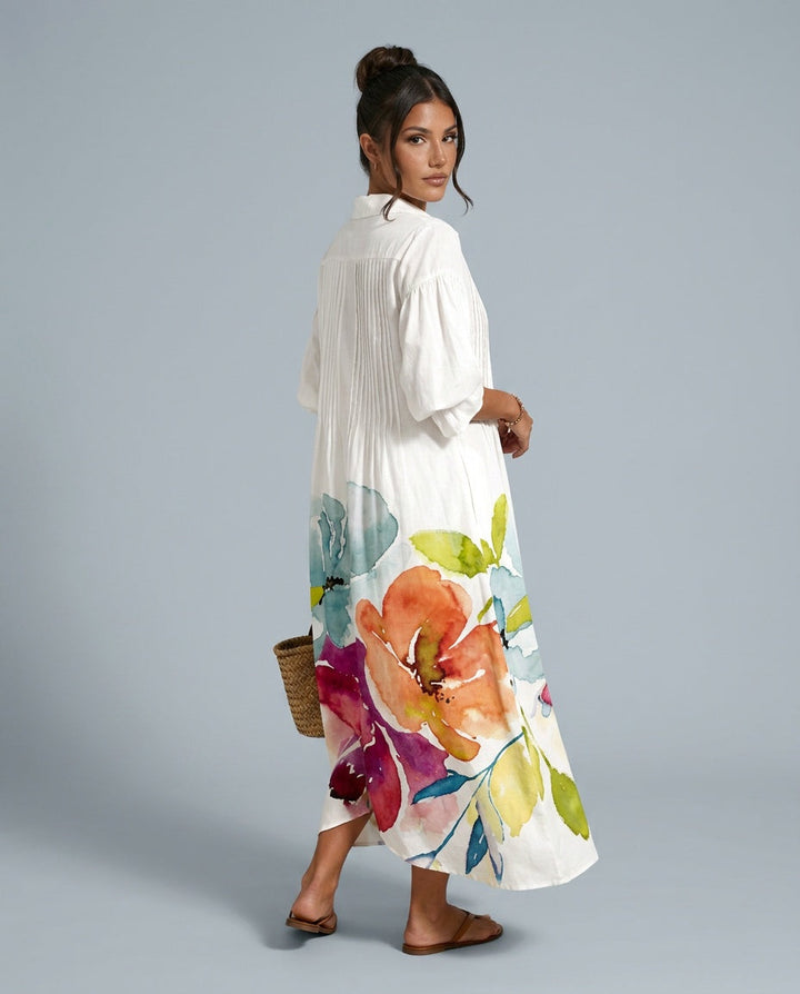 Vibrant floral print women's maxi dress with relaxed fit, button front & balloon sleeves. Perfect for summer.