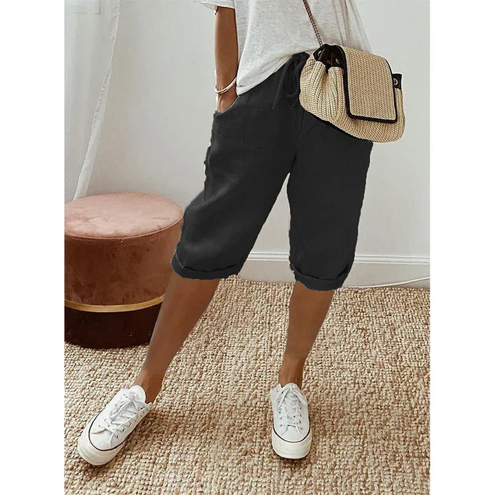 Chic women's cropped trousers featuring a relaxed fit & adjustable drawstring waist for elegant casual summer style.