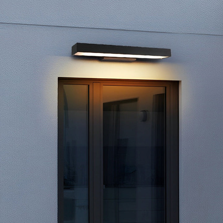 Modern black LED wall light with motion sensor for outdoor security & energy-efficient illumination.