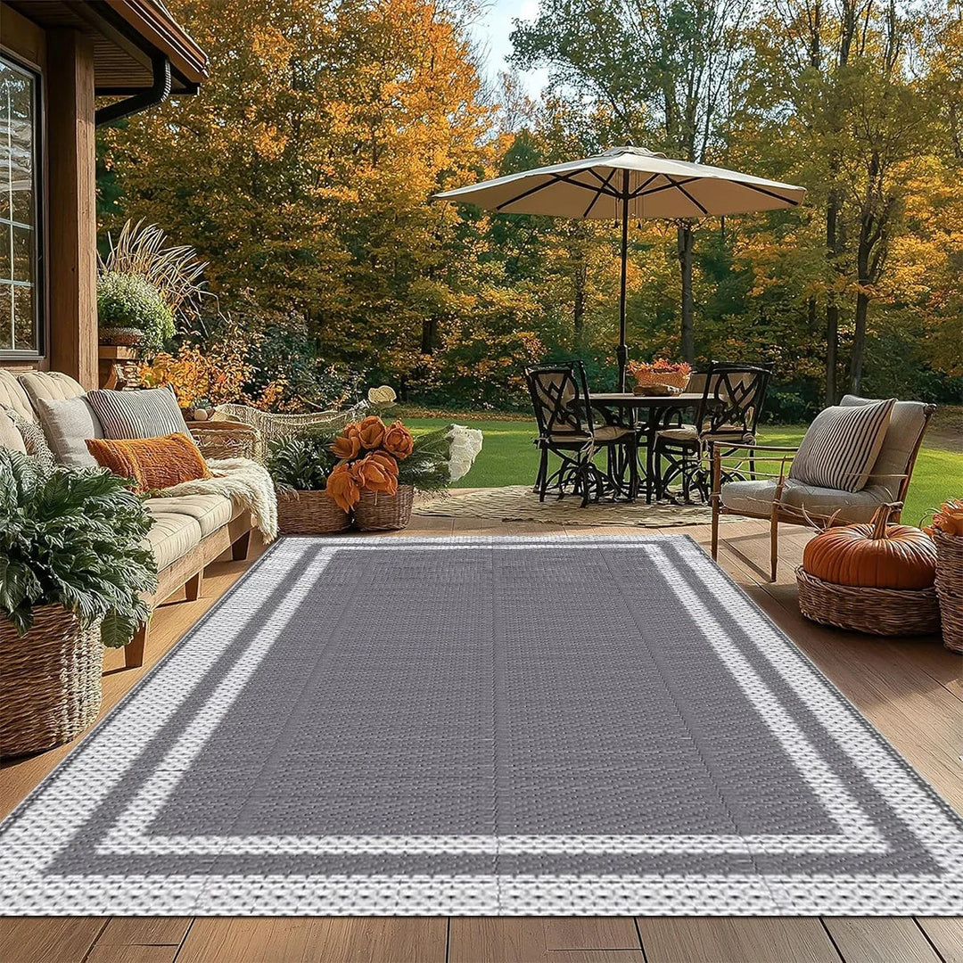 Stylish grey white rectangular outdoor mat with modern geometric pattern. Reversible, portable, and easy-clean for decks & patios.