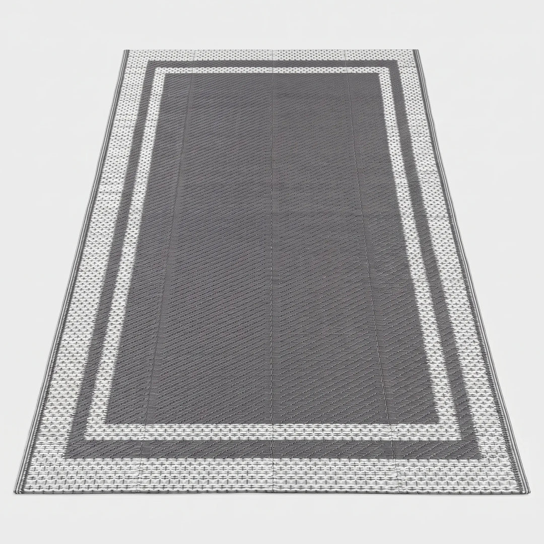 Reversible grey white rectangular outdoor mat, ideal for patio & deck. Modern geometric design, easy to clean & portable floor covering.